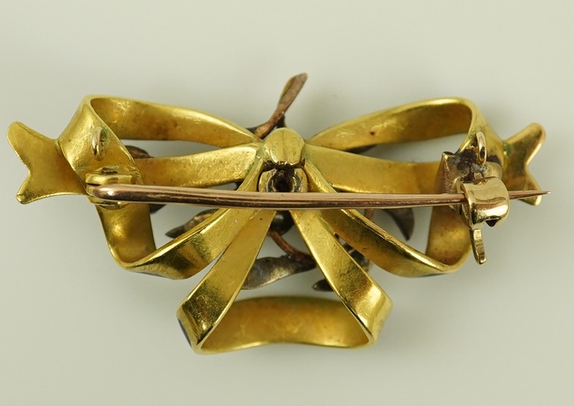 A Victorian gold, diamond cluster and blue enamel set ribbon bow brooch